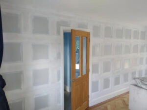 Panelling joints filled and sanded smooth before painting