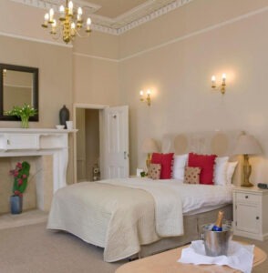 Elegant period bedroom with ornate cornicing, freshly painted in warm cream