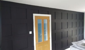 Close-up of dark grey panelled feature wall in matt finish